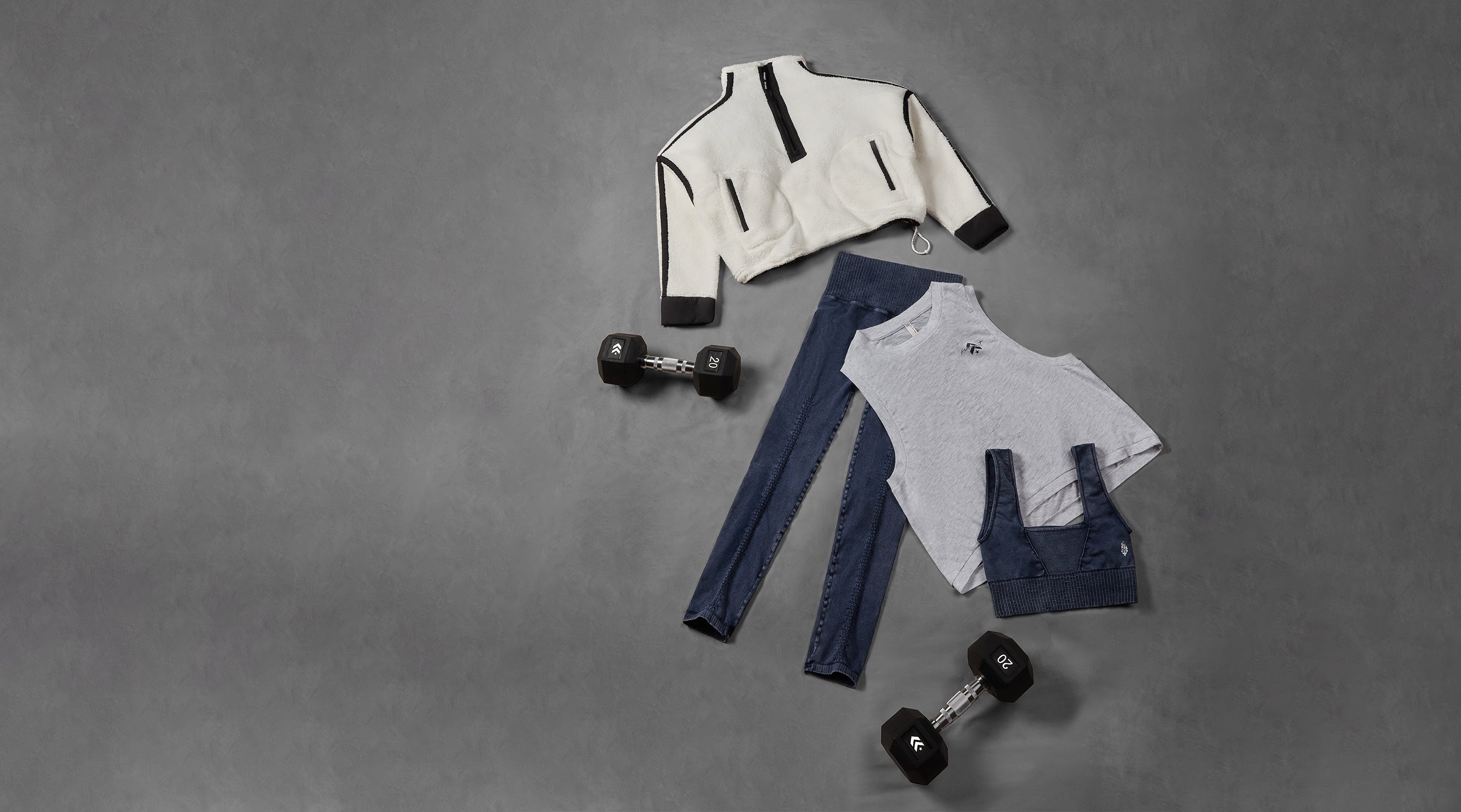 Clothing items including a jacket, leggings, and a top with suspenders on a gray background.