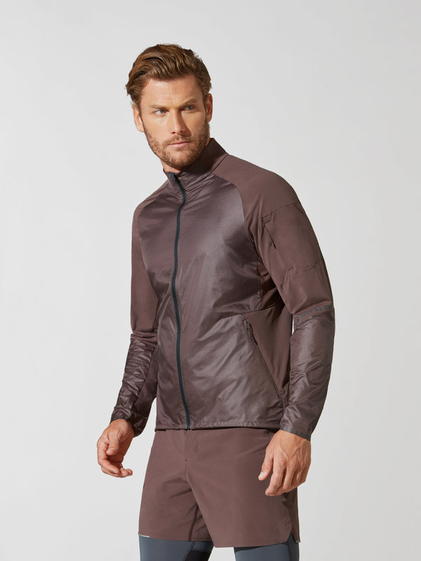 side view of male model in shiny mauve athletic jacket and matching mauve shorts